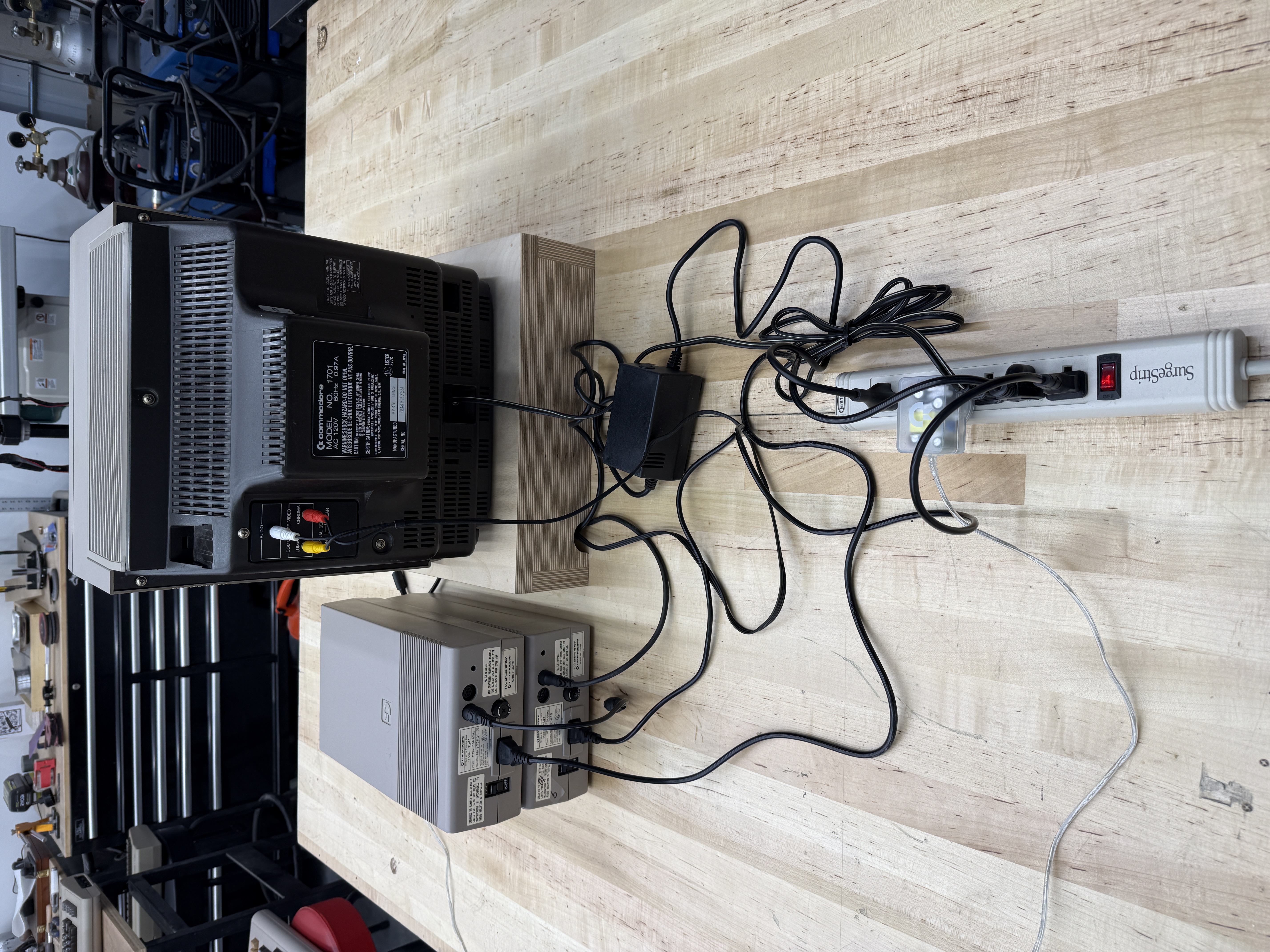 The current bench setup with monitor and replacement power supplies cabled up