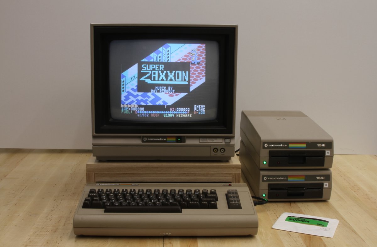 A restored Commodore 64 with 1701 monitor and two stacked 1541 drives running Super Zaxxon