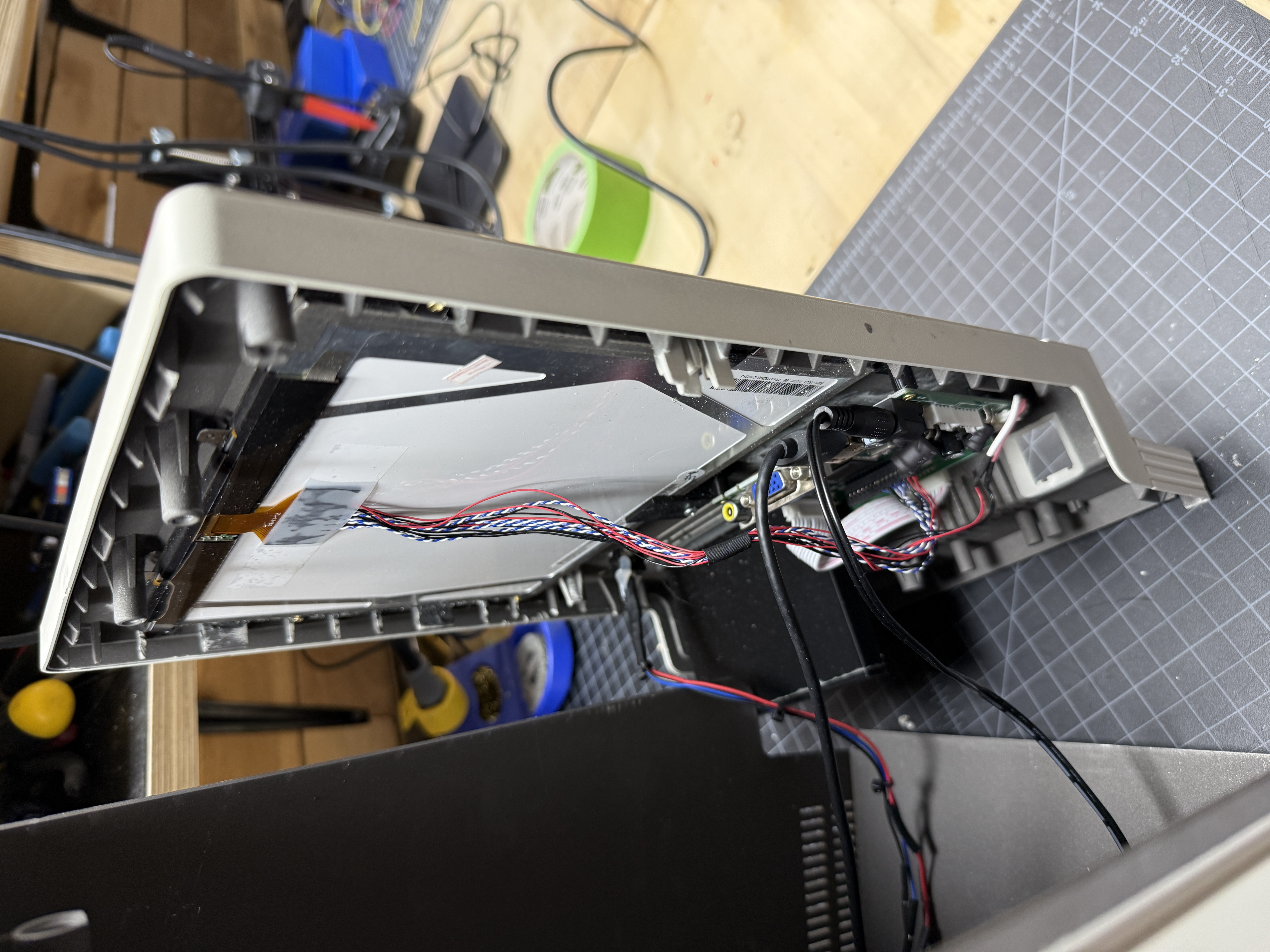 Front bezel separated from the case showing the LCD panel and wiring