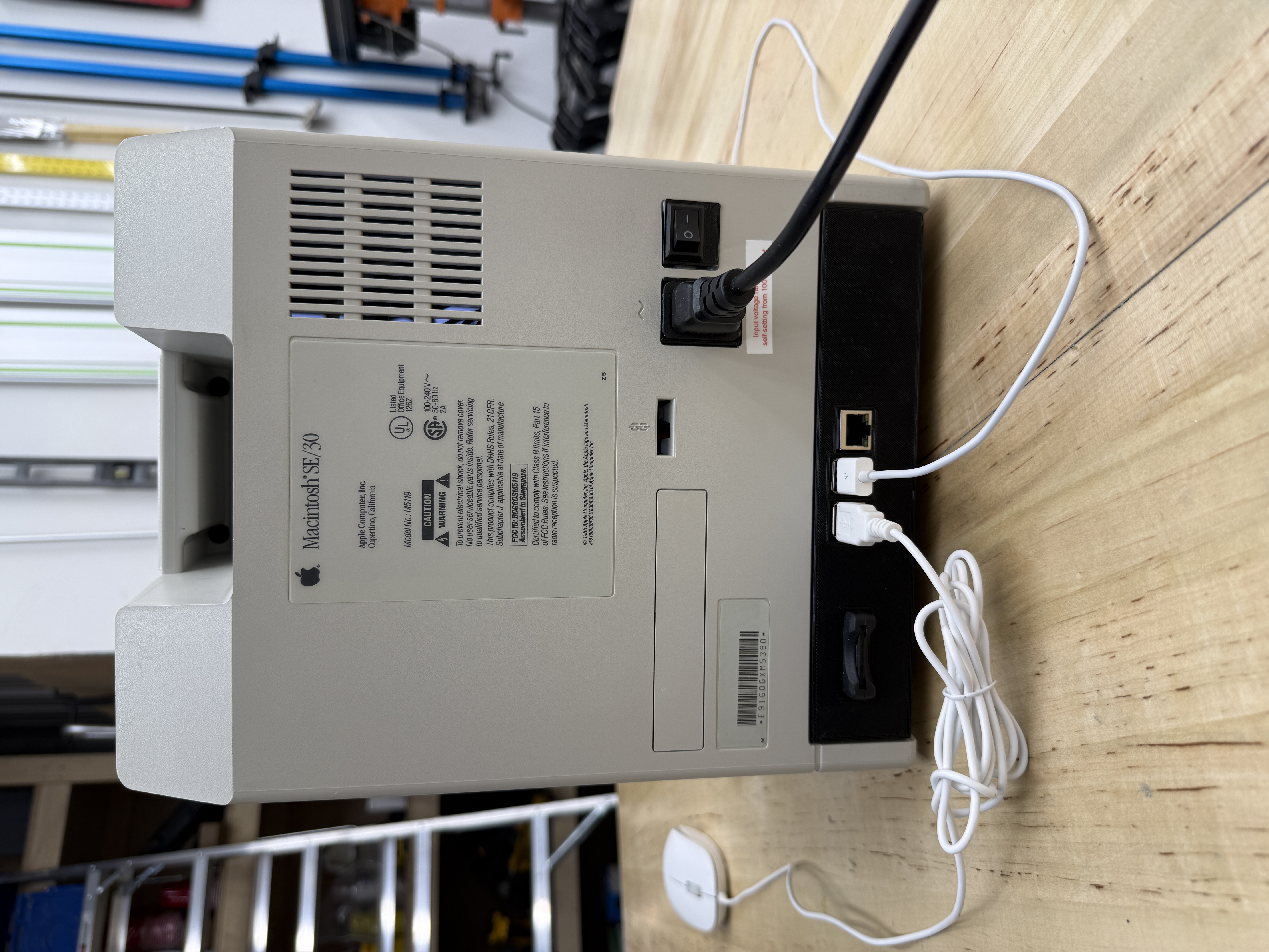 Three-quarter back view of the finished machine on a wood workbench