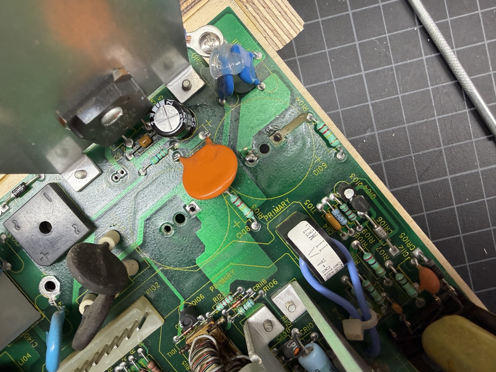 The C109 site on the main board with the broken trace running from the through-hole to a neighboring resistor